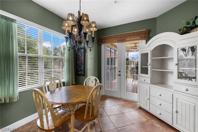 tiled dining area with french doors, an inviting chandelier, and built in features