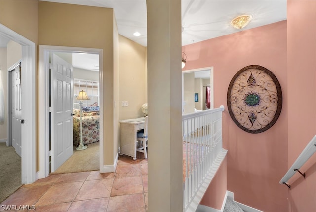 hall featuring light tile flooring