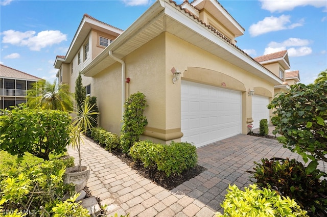 view of side of home with a garage