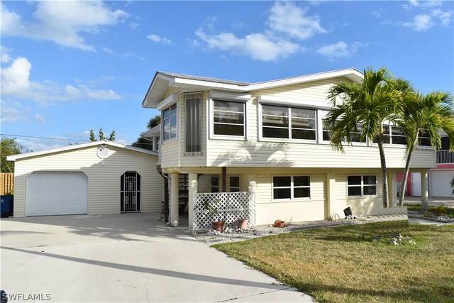 view of front of house with a front yard and a garage