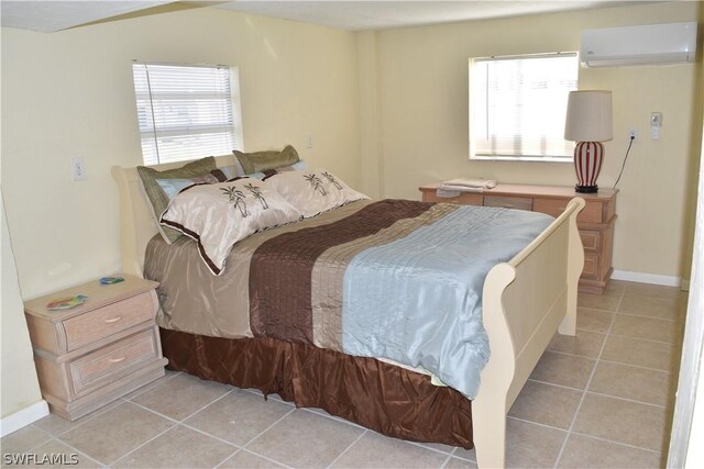 bedroom featuring a wall mounted AC and light tile floors