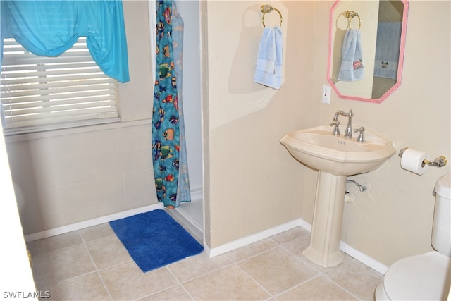 bathroom featuring tile floors and toilet