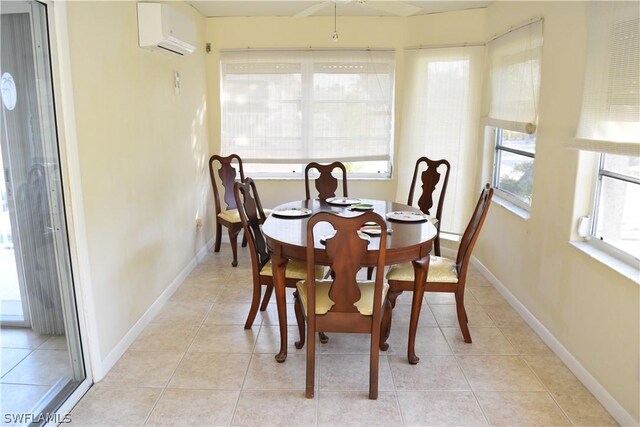 tiled dining room with plenty of natural light, ceiling fan, and a wall unit AC