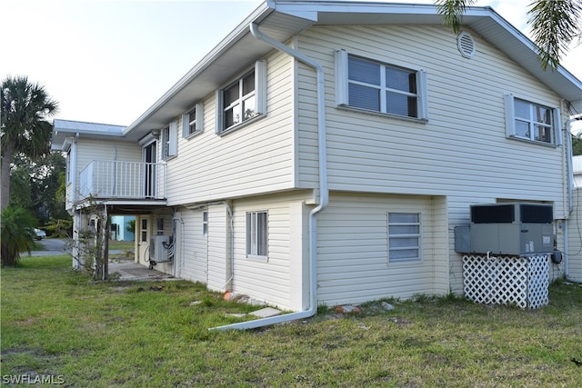 rear view of house featuring a yard