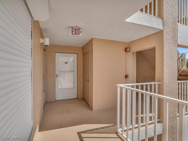 hallway featuring carpet floors and a textured ceiling