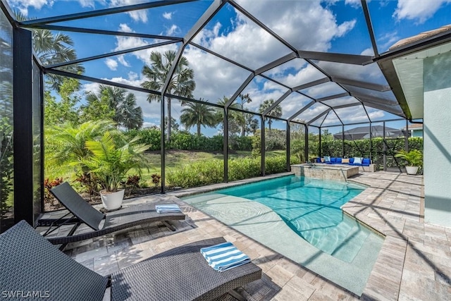 view of pool with glass enclosure, an in ground hot tub, and a patio