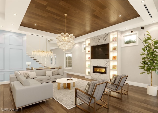 living room with an inviting chandelier, wood ceiling, a fireplace, and a tray ceiling