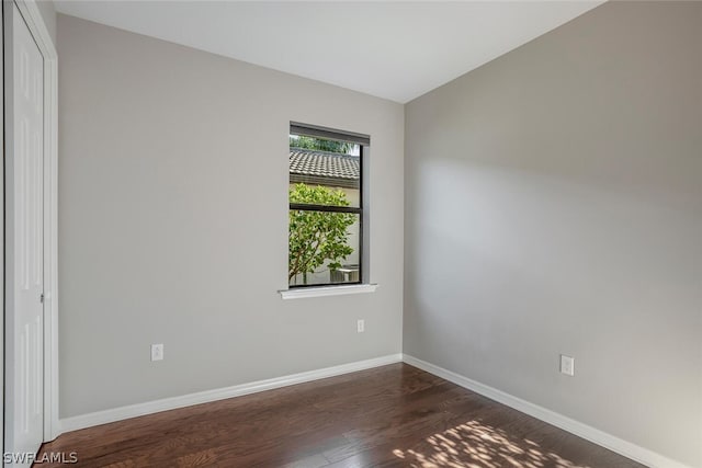 unfurnished room with dark hardwood / wood-style floors