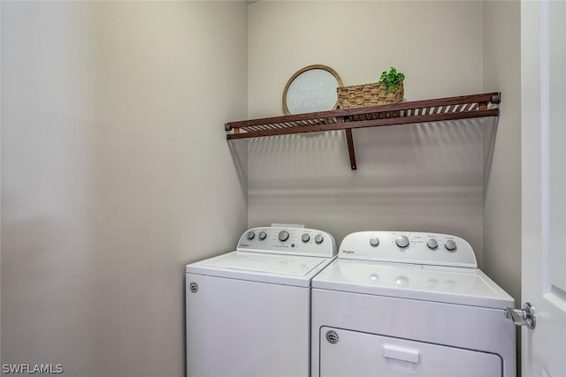 clothes washing area with washing machine and dryer