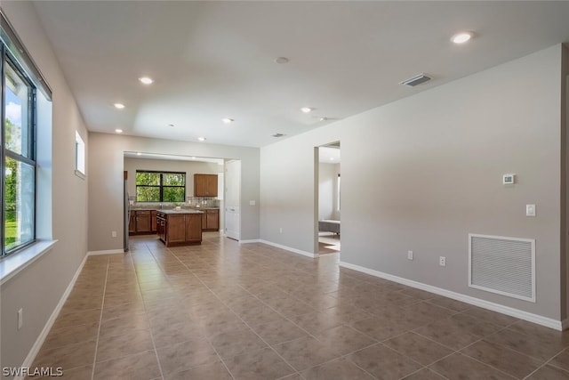 unfurnished living room featuring light tile patterned flooring