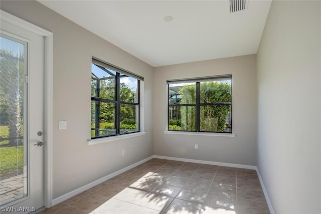 unfurnished room with light tile patterned floors