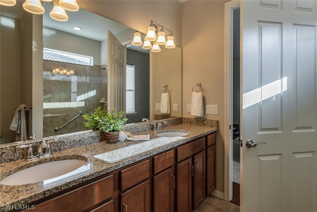 bathroom featuring vanity and a tile shower