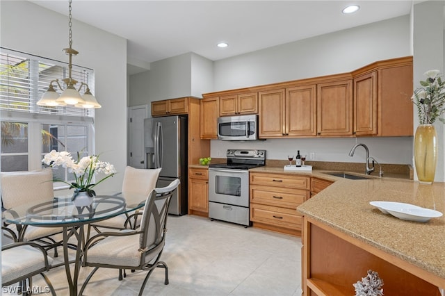 kitchen featuring appliances with stainless steel finishes, light tile floors, sink, pendant lighting, and light stone countertops