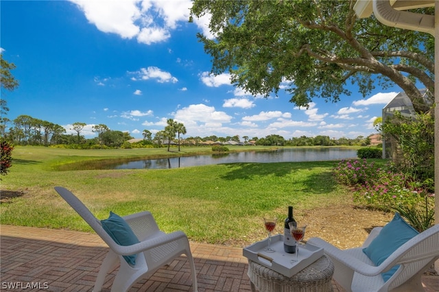 view of yard with a patio and a water view