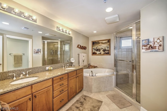 bathroom featuring independent shower and bath, tile floors, and dual bowl vanity