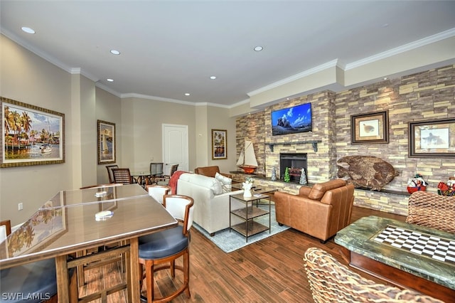 dining room with a fireplace, dark wood-type flooring, and ornamental molding