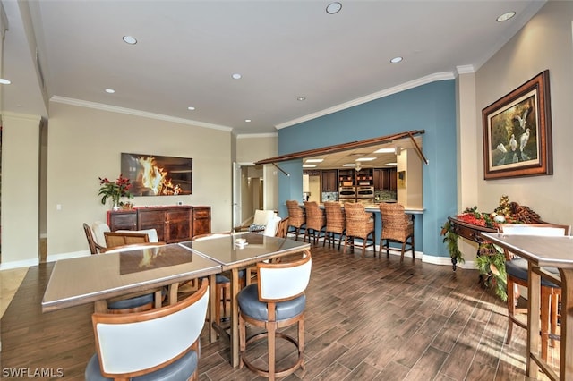 dining room with ornamental molding and dark wood-type flooring