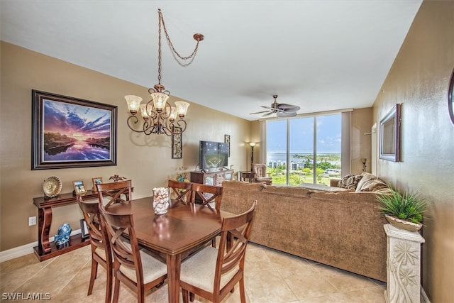 dining space featuring ceiling fan with notable chandelier and light tile flooring