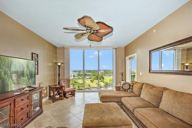 tiled living room with a wall of windows and ceiling fan