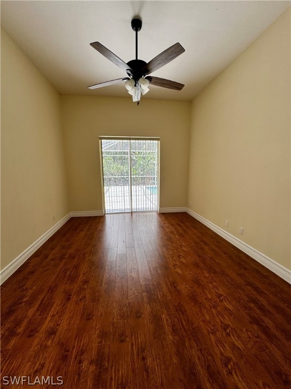 spare room with ceiling fan and dark hardwood / wood-style floors