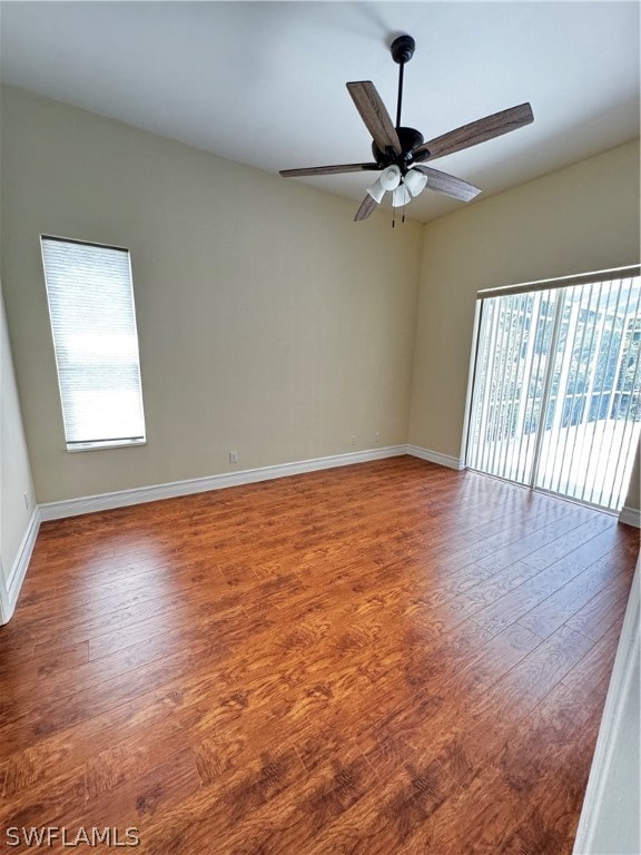 spare room featuring hardwood / wood-style floors, plenty of natural light, and ceiling fan