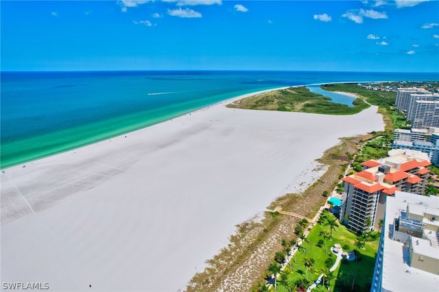 bird's eye view with a water view and a beach view