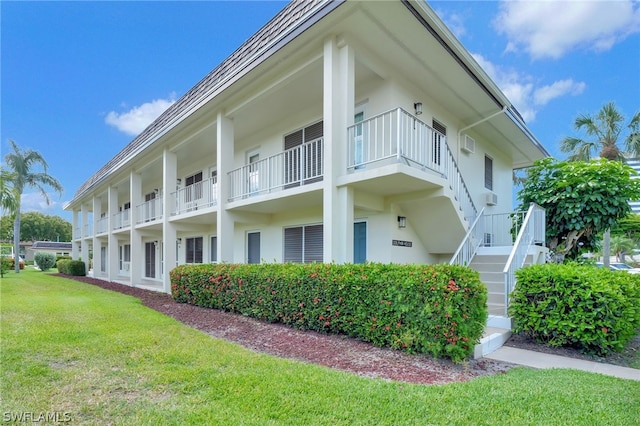 view of property exterior featuring a balcony and a lawn