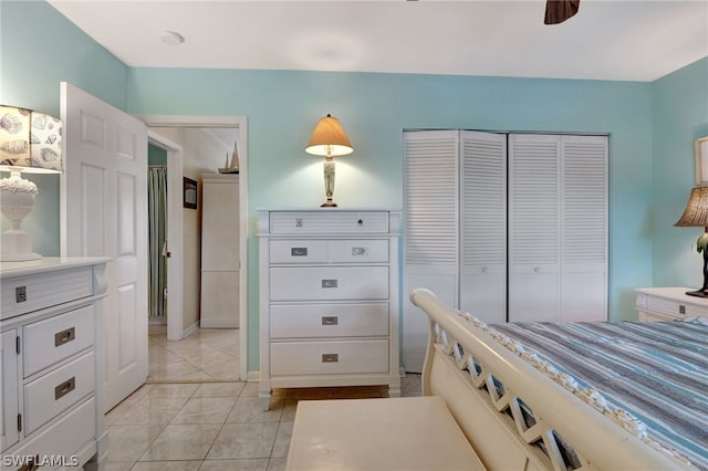 bedroom featuring a closet, ceiling fan, and light tile floors