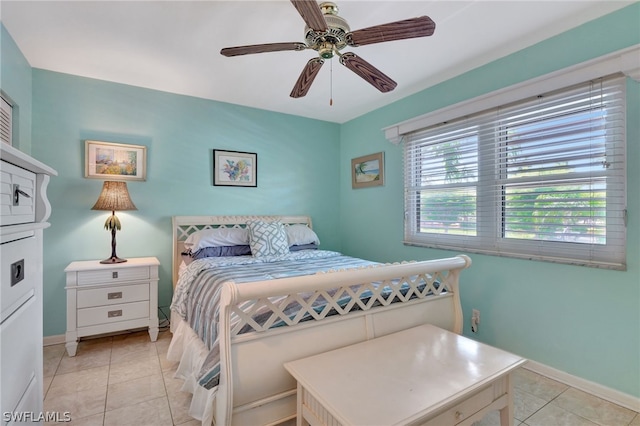 bedroom with ceiling fan and light tile floors