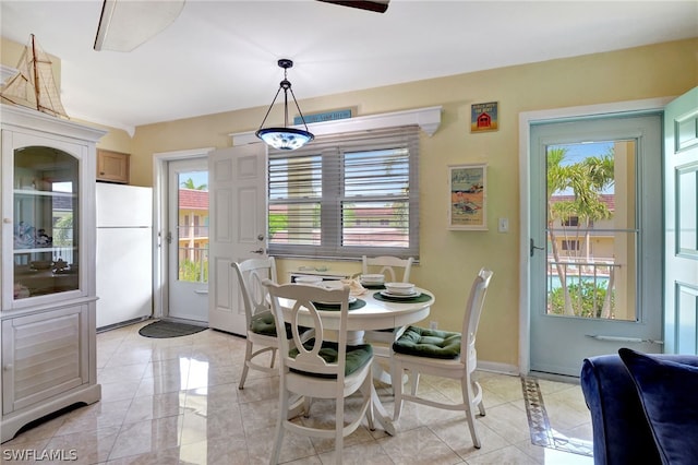 dining space featuring a wealth of natural light and light tile flooring