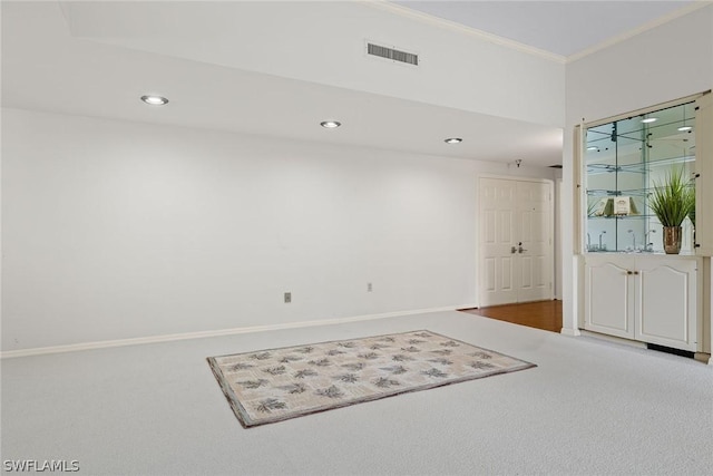 spare room with carpet flooring and crown molding