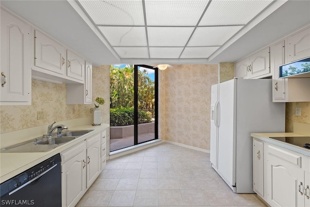 kitchen featuring electric stovetop, white refrigerator with ice dispenser, sink, white cabinets, and black dishwasher