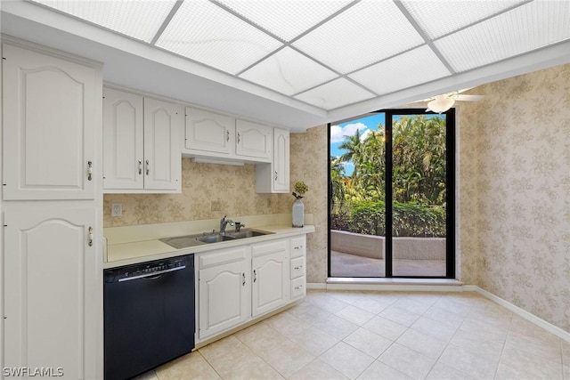 kitchen with dishwasher, white cabinetry, sink, and light tile patterned floors