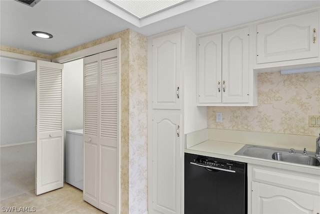 kitchen with dishwasher, light tile patterned flooring, white cabinetry, and sink