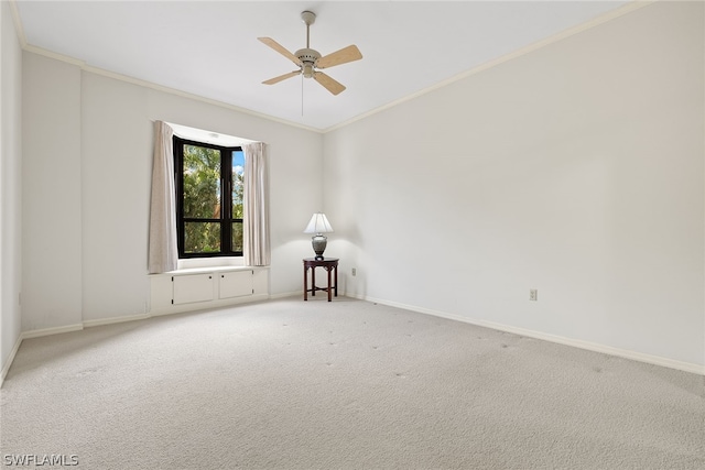 unfurnished room featuring carpet flooring, ceiling fan, and ornamental molding