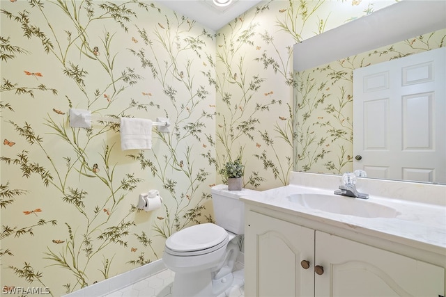 bathroom featuring tile patterned floors, vanity, and toilet