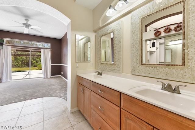 bathroom with a textured ceiling, ceiling fan, tile floors, and double sink vanity