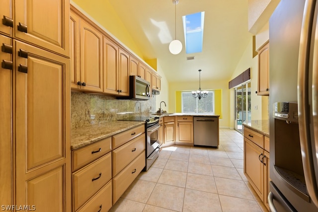 kitchen featuring hanging light fixtures, kitchen peninsula, appliances with stainless steel finishes, light tile floors, and a notable chandelier