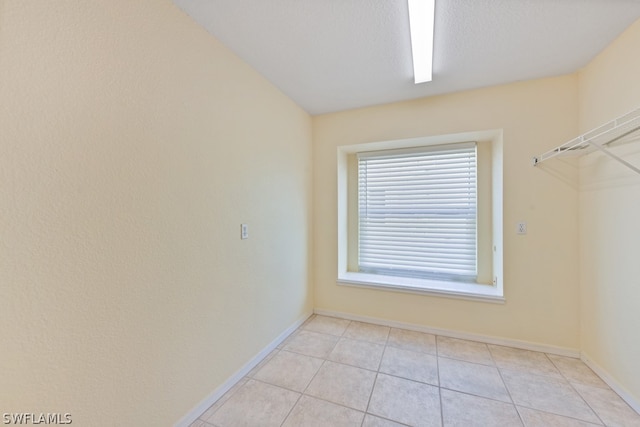 spacious closet featuring light tile floors