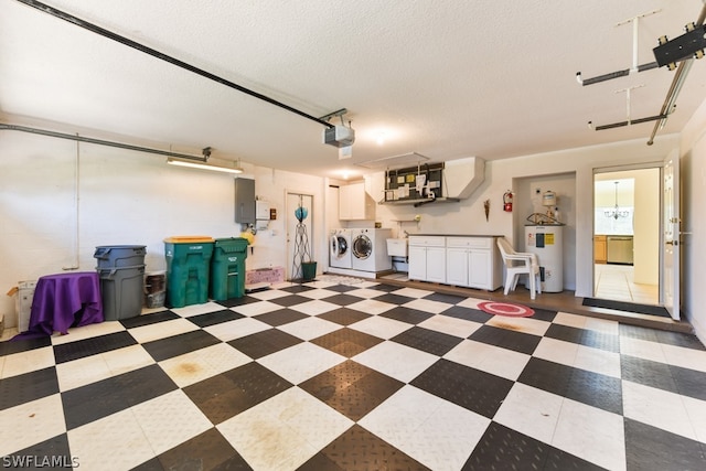 garage featuring a garage door opener, independent washer and dryer, and electric water heater