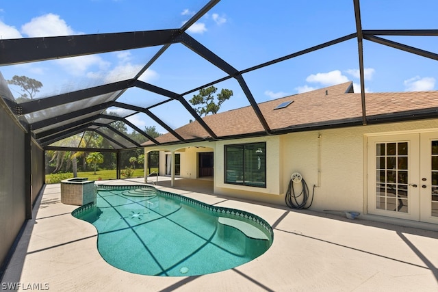 view of swimming pool featuring a patio, french doors, and a lanai