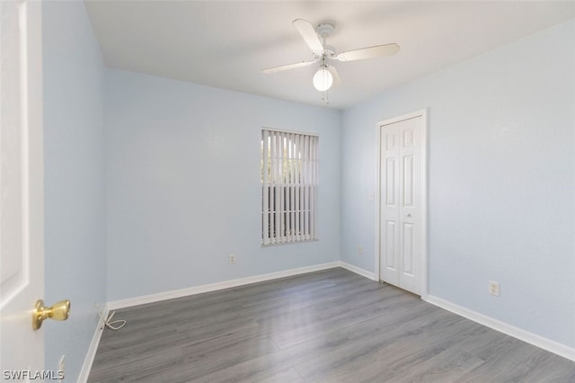 empty room featuring hardwood / wood-style flooring and ceiling fan