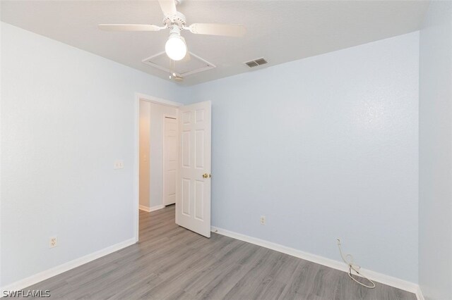 spare room featuring light wood-type flooring and ceiling fan