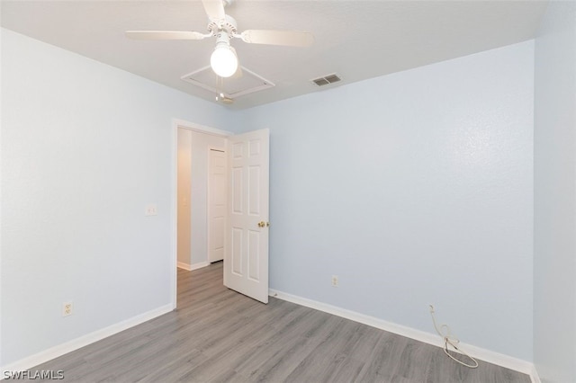 spare room featuring ceiling fan and light wood-type flooring