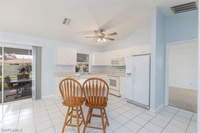 kitchen with white cabinetry, a kitchen breakfast bar, white appliances, and light tile patterned flooring