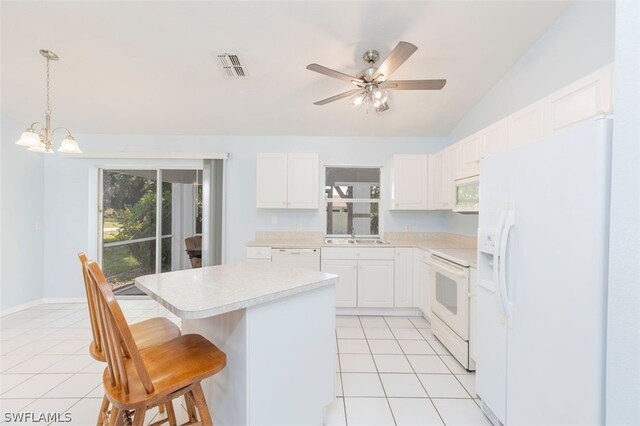 kitchen featuring a kitchen island, white cabinetry, white appliances, and pendant lighting