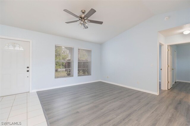 entrance foyer featuring vaulted ceiling, ceiling fan, and hardwood / wood-style floors