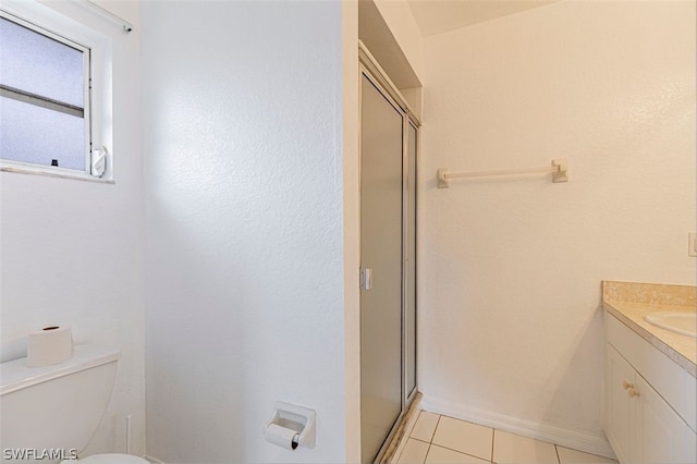 bathroom featuring vanity, toilet, a shower with door, and tile patterned flooring