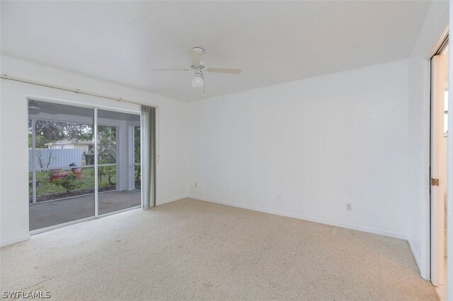 spare room featuring ceiling fan and light carpet