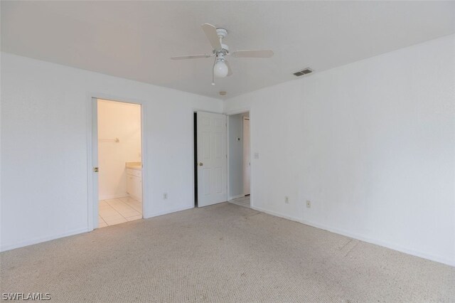 carpeted spare room with ceiling fan